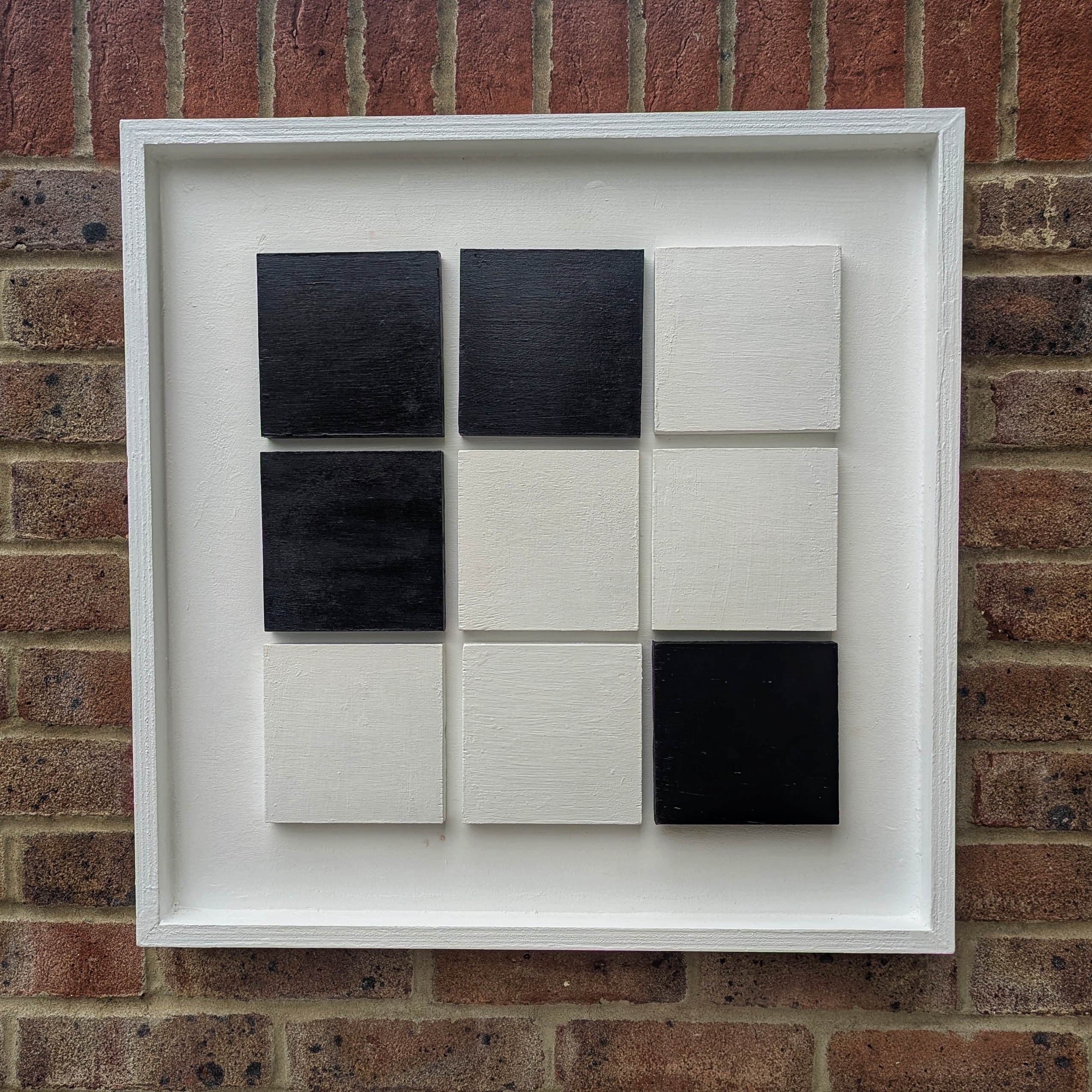 White vision board with magnetic style grid pattern in black.